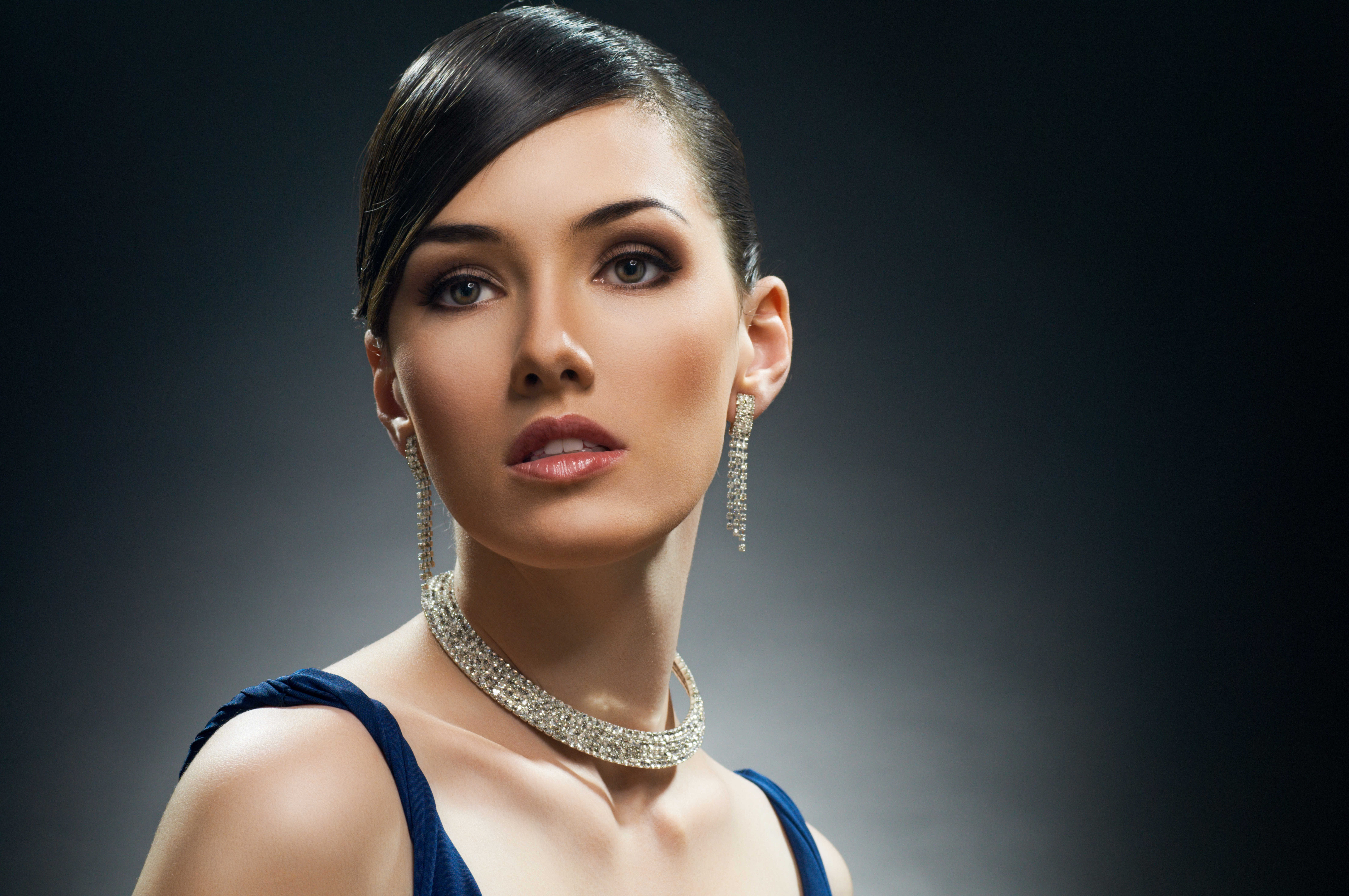 Woman with smooth side-swept bangs and hair pulled back